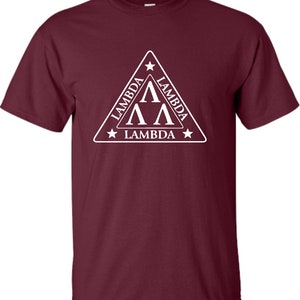May include: A maroon t-shirt featuring a white triangular design. The triangle has a white star at each point and the text "Lambda" written on each side. Inside the triangle are three white "A"s stacked on top of each other.