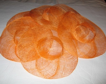 May include: A stack of orange straw hats, each with a different size and shape.