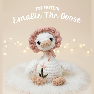 May include: A crocheted white goose toy named "Emalie The Goose" wearing a pink bonnet and a pink bow. The goose has a beige beak and feet, and a small flower is attached to its chest. The text "PDF PATTERN" and "Emalie The Goose" are displayed.