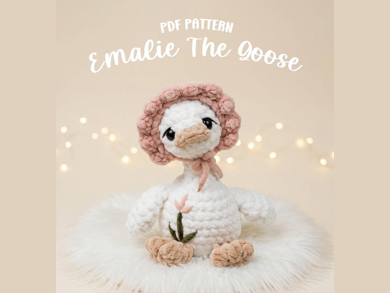 May include: A crocheted white goose toy named "Emalie The Goose" wearing a pink bonnet and a pink bow. The goose has a beige beak and feet, and a small flower is attached to its chest. The text "PDF PATTERN" and "Emalie The Goose" are displayed.