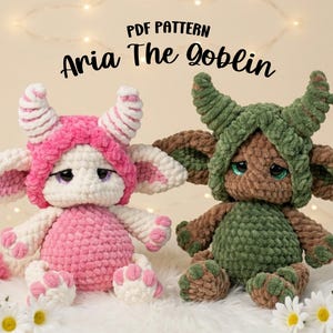 May include: Two handmade crochet goblin dolls, one in pink and white, the other in green and brown. The dolls have large ears, horns, and sad eyes. The text "PDF PATTERN Aria The Goblin" is at the top.