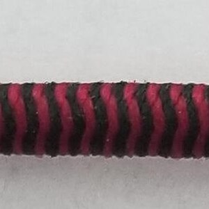 May include: A close-up of a red and black striped elastic cord.