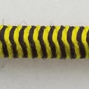 May include: A yellow and black striped cable with a zig-zag pattern.