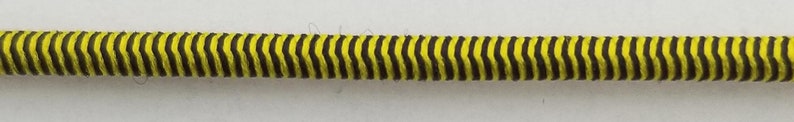 May include: A yellow and black striped cable with a zig-zag pattern.