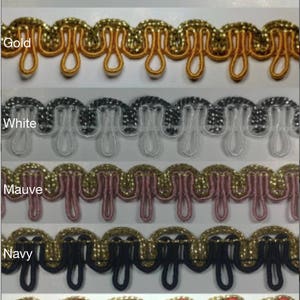 May include: Six different colors of trim with a gold thread running through it. The colors are dark green, gold, white, mauve, navy, and red.