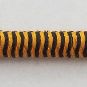 May include: A black and yellow striped elastic cord.