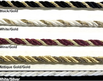 May include: Five samples of twisted rope trim with different color combinations. The colors are black and gold, white and gold, wine and gold, antique gold and gold, and white and silver.
