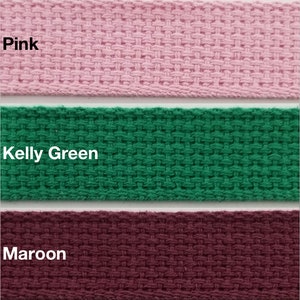 May include: Three fabric samples in pink, kelly green, and maroon. The fabric is a woven cotton webbing.