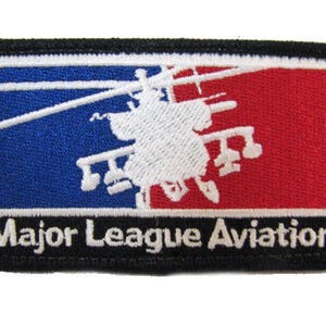 May include: A black and white embroidered patch with a white helicopter silhouette on a blue and red background. The text "Major League Aviation" is embroidered in white on a black background.