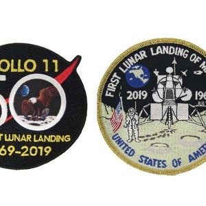 May include: Two embroidered patches commemorating the 50th anniversary of the Apollo 11 moon landing. The left patch is black with white text and a red and white stripe. It reads "Apollo 11 50 The First Lunar Landing 1969-2019". The right patch is beige with a gold border and features a depiction of the lunar module landing on the moon. It reads "First Lunar Landing of Mankind 2019 1969 July 20 United States of America".