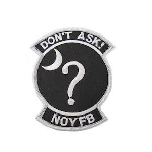 May include: Embroidered patch with the words "DON'T ASK!" in white on a black background. A white question mark and crescent moon are in the center. The letters "NOYFB" are at the bottom, all with a silver border.
