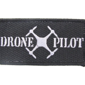 May include: Black embroidered patch with white text that reads "DRONE PILOT" and a white drone symbol.