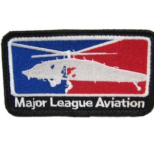 May include: A black and white embroidered patch with a red, white, and blue design. The patch features a helicopter and the text "Major League Aviation".