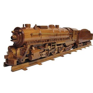 May include: A wooden model of a vintage steam locomotive train with brown and black details. The train is on a wooden track.