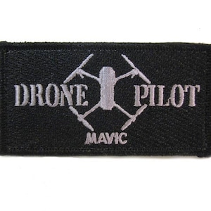May include: Black embroidered patch with white text that reads "Drone Pilot" and a stylized drone graphic with the text "Mavic" below.