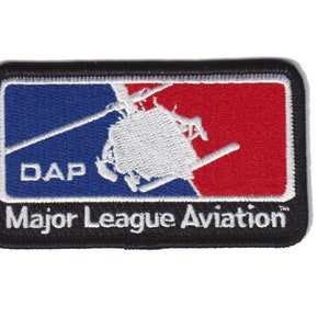 May include: A black and white embroidered patch with a red, white, and blue background. The patch features a helicopter and the text "DAP Major League Aviation".