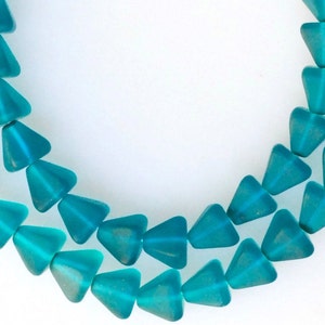 May include: A strand of teal blue glass beads in a triangular shape.