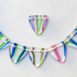 May include: A necklace made of clear glass triangle beads with blue, green, and pink stripes. The beads are strung on a clear thread.