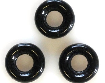 May include: Three black rubber o-rings. The o-rings are round with a hole in the center.
