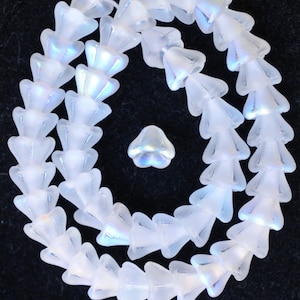 May include: A strand of iridescent white glass beads in a teardrop shape. The beads are arranged in a circle and have a frosted finish.