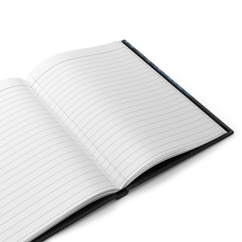 May include: Open notebook with lined pages. The notebook has a black cover and a white interior with gray lines. The pages are open, revealing the lined paper. The notebook is on a white background.