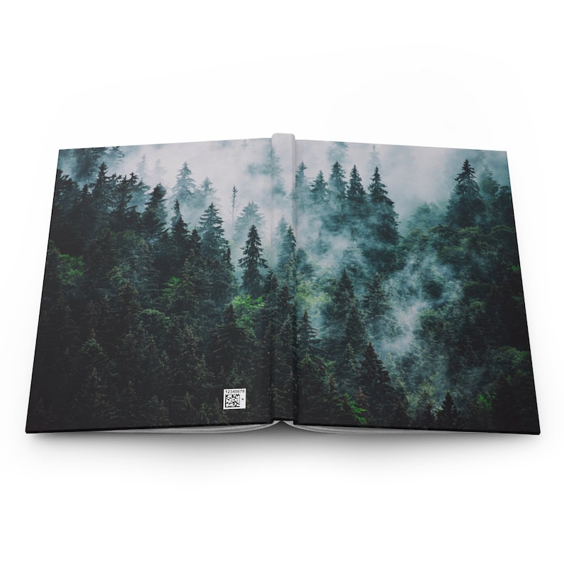 May include: A book with a photo of a misty forest on the cover. The forest is dense with tall, green trees. The photo is split across two pages.