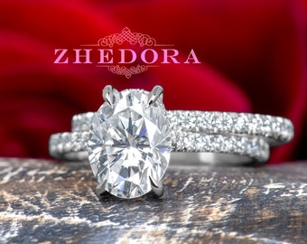 May include: A silver engagement ring set with a large oval-shaped diamond and a smaller diamond band. The ring is set against a red rose.