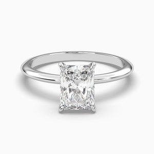 May include: A silver ring with a large, clear, rectangular-shaped diamond.