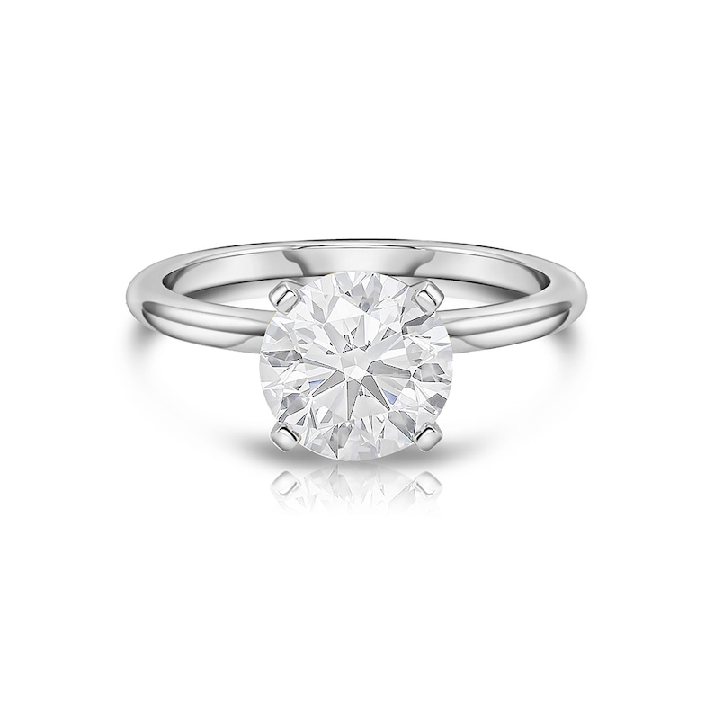 May include: A silver solitaire engagement ring with a large, round, clear diamond.