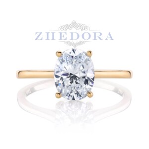 May include: A gold engagement ring with an oval-shaped diamond.