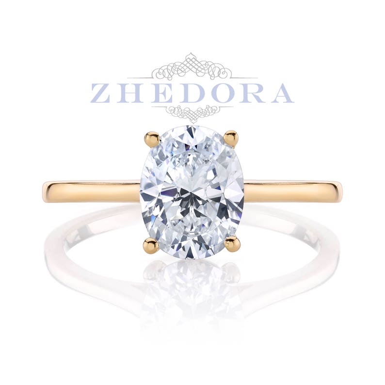 May include: A gold engagement ring with an oval-shaped diamond.