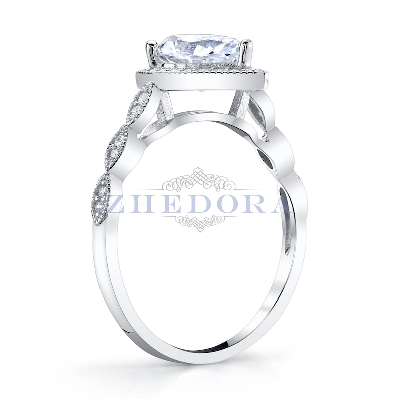 May include: A silver ring with a large, clear, round gemstone surrounded by smaller gemstones. The band is decorated with a delicate, intricate design.