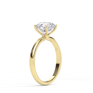 May include: A gold engagement ring with a large, round, clear diamond.
