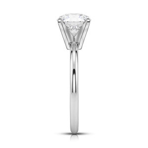 May include: A silver solitaire engagement ring with a large, round, clear diamond.