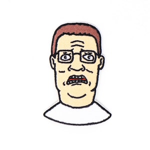 May include: A cartoon patch of a man with brown hair, wearing glasses and a white shirt. He has a surprised expression on his face.