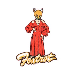 May include: An embroidered iron-on patch featuring a fox wearing a red dress and the word "Fox Trot" in yellow lettering.