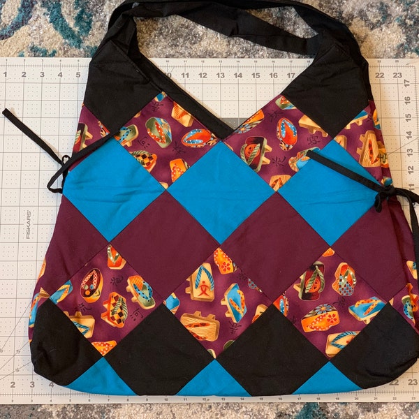 New Handmade tote bag made from a Asian shoes fabric, black, teal & burgundy fabric. Spacious bag expands if needed to carry larger items.