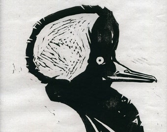 May include: Black and white linocut print of a bird's head with a large crest. The bird is facing to the right and has a long beak.