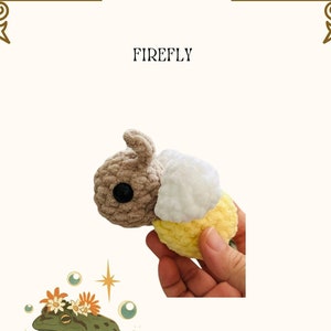 May include: A crocheted firefly toy with a brown head, white wings, and a yellow body. The toy is being held in a hand. The word "FIREFLY" is written in black text above the toy.