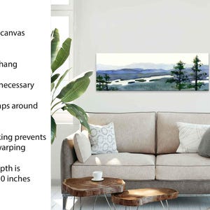 May include: A stretched canvas print of a watercolor landscape with a river and trees. The print is ready to hang and has a rigid backing to prevent sagging or warping. The canvas depth is 1.25 to 1.50 inches.