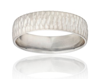 May include: A silver wedding band with a hammered finish.