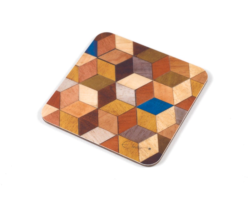 May include: Square wooden coaster with a geometric cube pattern in shades of brown, tan, and blue. The coaster has rounded corners and a light-colored border. The design is made of various wood tones.