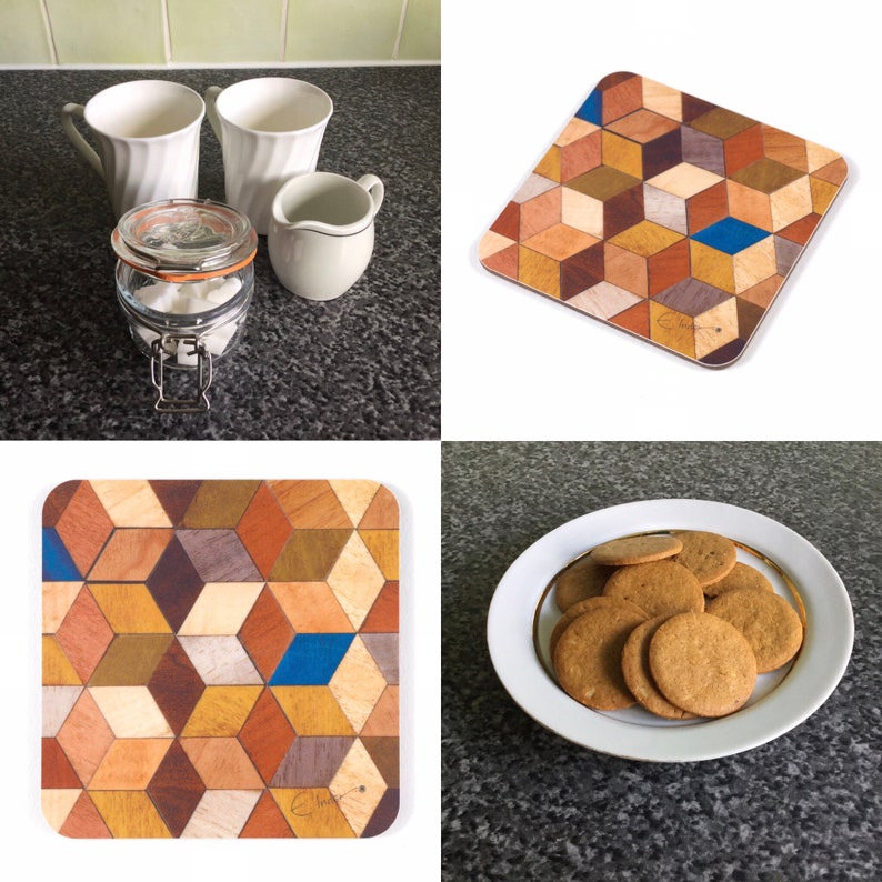 May include: A collection of kitchen items including white mugs, a creamer, a glass jar with sugar cubes, a wooden coaster with a geometric pattern, and a plate of cookies. The coaster features a cube design with various wood tones.