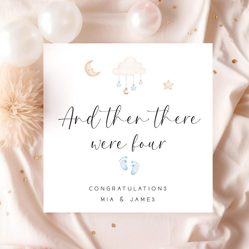 May include: A white card with a blue and white cloud with stars and a moon hanging from it. The text on the card reads "And then there were four" with blue baby footprints below. The card also says "Congratulations Mia & James".
