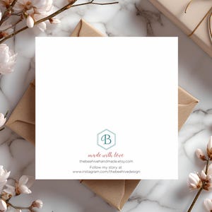 May include: A white card with a teal blue hexagon logo with the letter "B" inside. The text "made with love" is in pink below the logo. The text "thebeehivehandmade.etsy.com" is in black below the pink text. The text "Follow my story at www.instagram.com/thebeehivedesign" is in black below the website address.