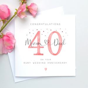 May include: A white card with a pink watercolour number 40 and the words "Mum & Dad" on your Ruby Wedding Anniversary. The card is decorated with small red hearts and stars.