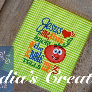 May include: A framed artwork with a green and white chevron background. The artwork features the text "Jesus loves me, this I know, for the Bible tells me so" with a cartoon tomato illustration. The frame is made of weathered wood.