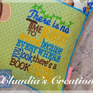 May include: Green and yellow cushion with a monkey design and the text "There is no time to monkey around because EVERYWHERE you look there's a BOOK to be found". The cushion has a blue border and a pink tag that says "Claudia's Creations".