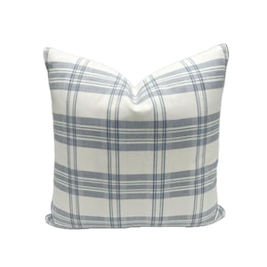 May include: A white pillow with a blue and white plaid pattern.