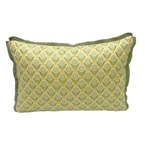 May include: A yellow pillow with a green floral pattern and a green border.